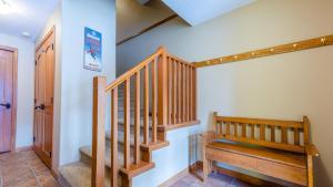 a staircase in a room with a wooden stair case at Trails Edge #03 By Bear Country in Sun Peaks