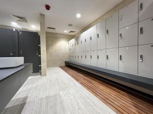a locker room with white cabinets and a wooden floor at NEW Luxury Sunrise Oceanview Aparthotel in Gibraltar in Gibraltar