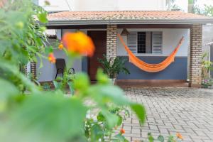a house with an orange hammock in front of it at Pousada Vento Sul in Chapada dos Guimarães