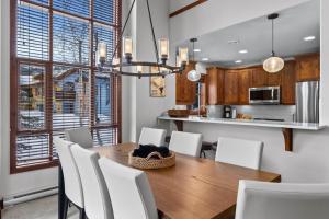 a kitchen and dining room with a wooden table and chairs at Trappers Landing #05 By Bear Country in Sun Peaks