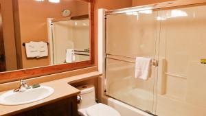 a bathroom with a shower and a sink and a toilet at Trappers Landing #34 in Sun Peaks +22 photos