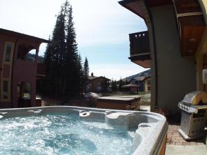 a large jacuzzi tub in the backyard of a house at Crystal Forest #04 By Bear Country in Sun Peaks