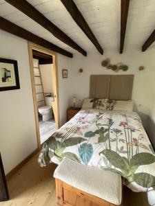 a bedroom with a bed and a bathroom at La Casina del Corral in Cangas de Onís