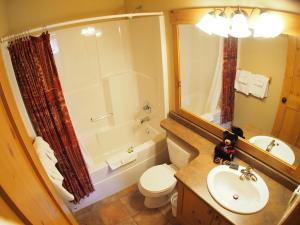 a bathroom with a toilet and a sink and a shower at Crystal Forest #72 By Bear Country in Sun Peaks