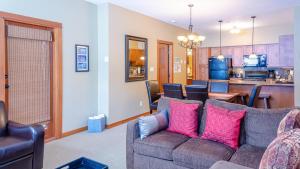 a living room with a couch and a kitchen at Settlers Crossing #61 by Bear Country in Sun Peaks +19 photos