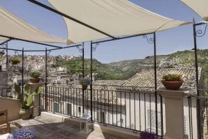 a balcony with a view of a city at Casa Hybla in Ragusa