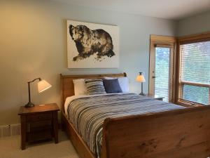 a bedroom with a bed and a window at On the Run Chalet by Bear Country in Sun Peaks