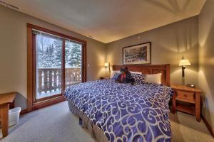 a bedroom with a large bed and a window at Timberline Village #14 By Bear Country in Sun Peaks