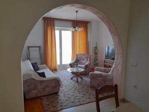 an arched room with a living room with a couch and chairs at VILLA Apartments Mate Cebalo in Lumbarda