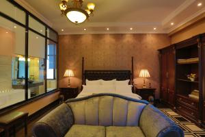 a bedroom with a bed and a couch at The Residence Hotel in Addis Ababa