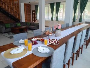 a long wooden table with plates of food on it at Casa Phoenix in Băişoara