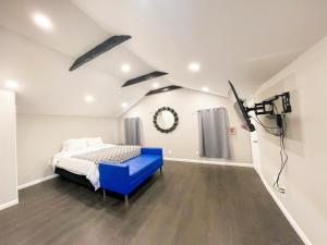 a bedroom with a blue bed and a spotlight at Penn Lodge Hotel & Suites Philadelphia - Bensalem in Bensalem