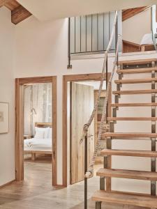a spiral staircase in a room with a bedroom at Firefly Luxury Suites in Zermatt