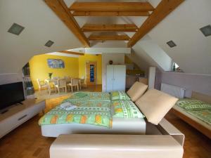 a bedroom with a large bed and a dining room at Oriana Studios in Bled