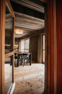 jadalnia ze stołem i drewnianą podłogą w obiekcie Exzelent Residence w mieście Anterselva di Mezzo