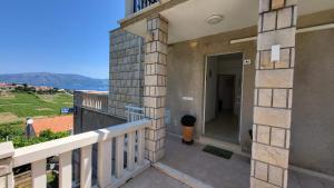 a balcony with a view of the ocean at VILLA Apartments Mate Cebalo in Lumbarda