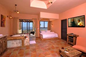 a large room with a bed and a bathroom at קאמי מלון בוטיק עם ממ"ד - Kami Boutique Hotel in Safed