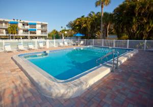 a large swimming pool with a brick walkway around it at Gulf Tides of Longboat Key in Longboat Key