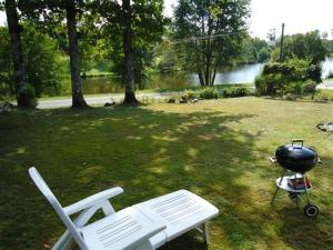 a grill and a picnic table in a yard at Village Le Chat 3 Écuras in Écuras +4 photos