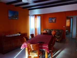 a dining room with a table and a couch at Appartement de 2 chambres avec vue sur la mer terrasse amenagee et wifi a Bouillante a 4 km de la plage in Bouillante