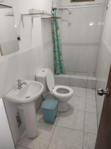 a bathroom with a toilet and a sink at CasaBlanca in Nazca