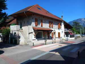un bâtiment avec un toit rouge dans une rue dans l'établissement Maison à 5 minutes du lac à pied, à Aix-les-Bains