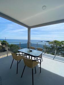 a table and chairs on a balcony with a view of the ocean at Apartments Klikovac Liman II in Ulcinj