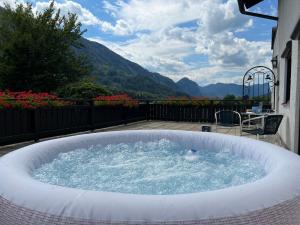 a jacuzzi tub on a patio with a view at Die Landhausvilla in Unterach am Attersee in Unterach am Attersee