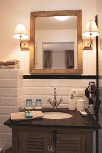 a bathroom with a sink and a mirror at La Forteresse in Borgloon