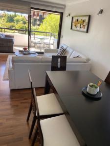 a living room with a couch and a table at Departamento Pucón in Pucón +22 photos