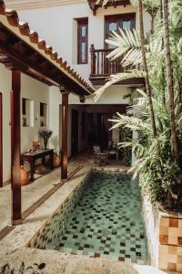 a swimming pool in the courtyard of a house at Hotel Boutique Santo Toribio in Cartagena de Indias