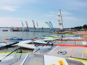 a bunch of boats are lined up on the water at Przyczepa kemping Chałupy 3 Półwysep Hel in Chałupy