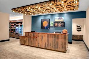 a restaurant lobby with a wooden counter and blue walls at SpringHill Suites by Marriott Bozeman in Bozeman
