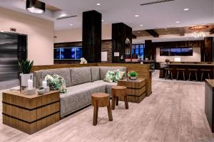 a lobby with a couch and tables and a bar at SpringHill Suites by Marriott Bozeman in Bozeman