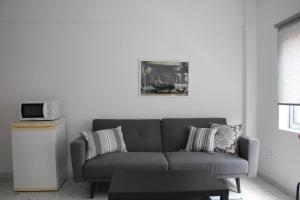 a living room with a couch and a table at Amalia Residences in Nicosia