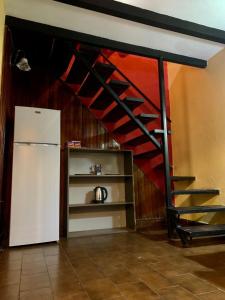 a room with a staircase next to a refrigerator at Renty Herrera in Asuncion