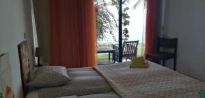 a bedroom with a bed and a large window at Sea to see - sea front view in Caniço +12 photos