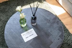 a round table with two vases with flowers on it at Hotel Zweite Heimat Nürburg in Kelberg