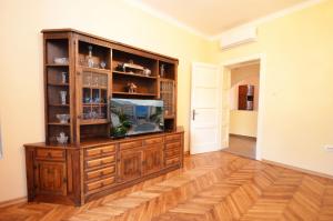 a living room with a television in a wooden entertainment center at Apartment Anima in Tivat