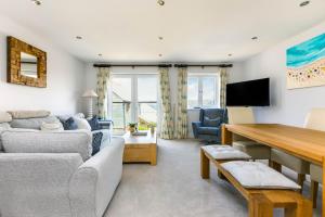 a living room with a couch and a table at Rock Lobster in Port Isaac