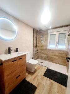 a bathroom with a toilet and a sink and a tub at Apartamento Moises in Santander