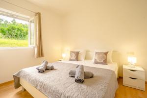 a bedroom with a bed with pillows and a window at Bepo Apartments at beach in Metajna