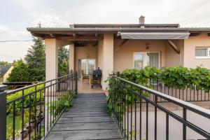a house with a staircase leading to the front porch at Adél Vendégház in Zamárdi