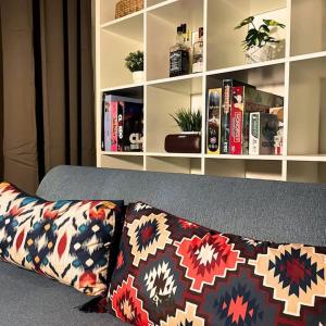 a pillow on a couch with a book shelf at Villa Siku Naim, Sukabumi in Sukabumi
