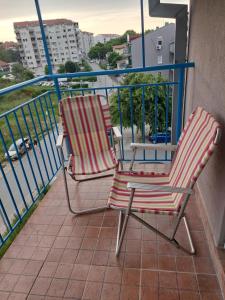 2 sillas y una mesa en el balcón en Flat 23, en Belgrado