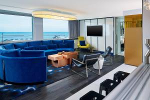 a living room with a blue couch and a tv at W Chicago - Lakeshore in Chicago