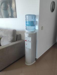 a water cooler with a bucket on top of a refrigerator at Benalbeach Penthouse Sea View in Benalmádena
