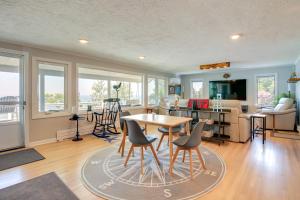 a living room with a table and chairs at Bayfront Home with Deck - 4 Mi to Downtown Plymouth! in Plymouth