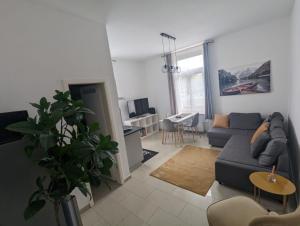 a living room with a couch and a table at Schönes Apartment am Rhein - Zentral in Koblenz
