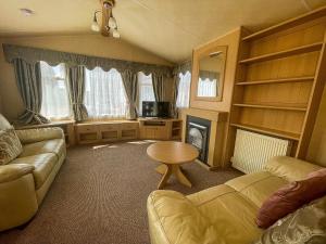 a living room with a couch and a table at 4 Berth Nearby Hunstanton Beach In Norfolk Ref 13018l in Hunstanton